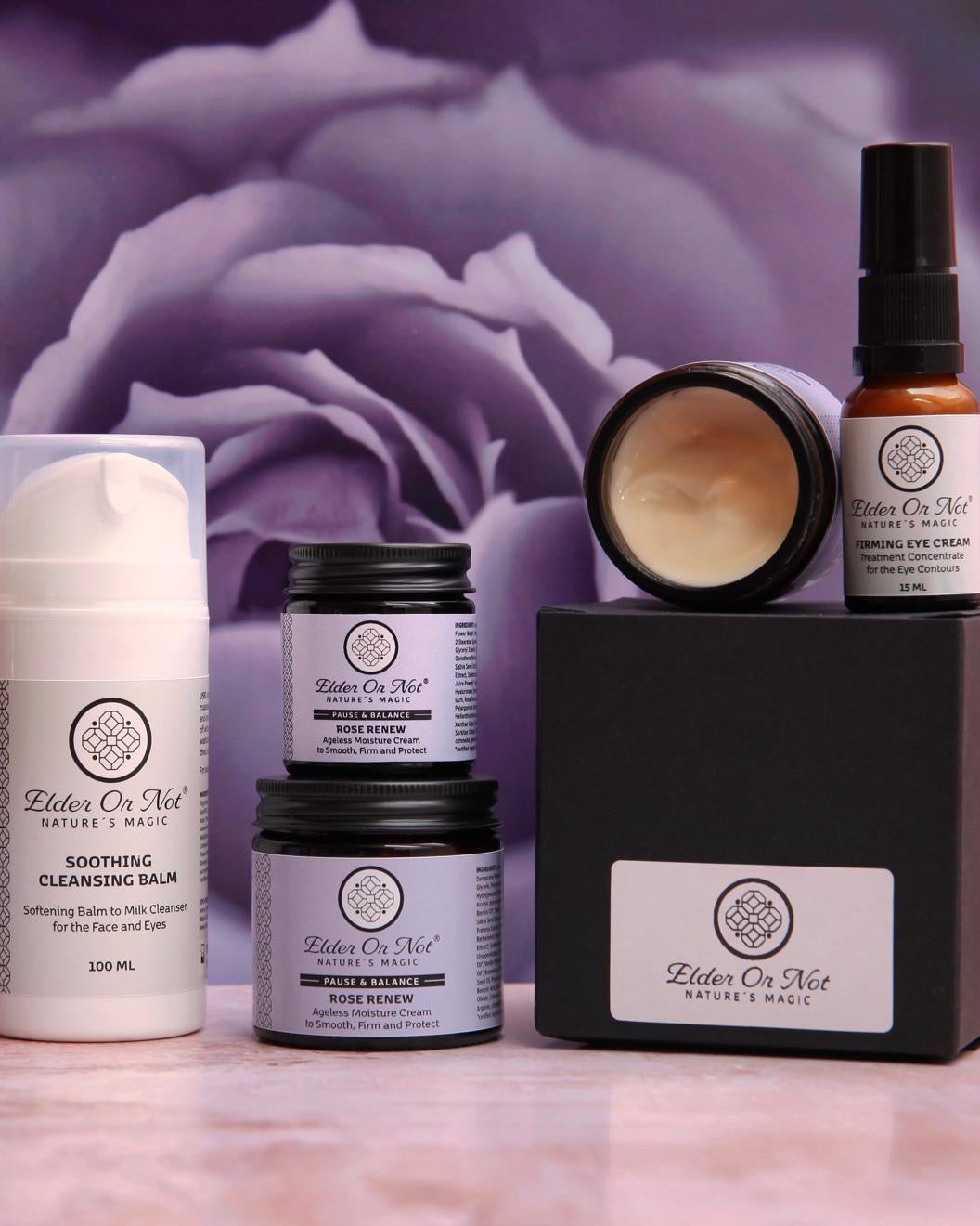 Collection of Elder Or Not Skincare products with a purple rose in the background
